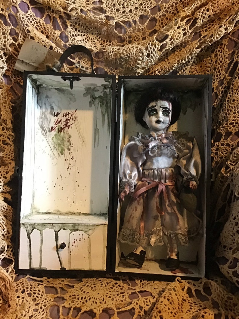 porcelain doll in wooden box