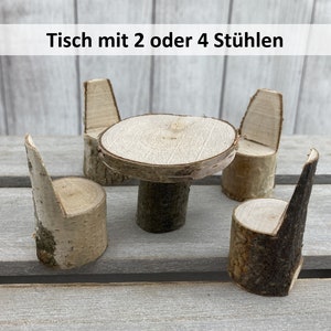 May include: A miniature wooden table and chairs set. The table is made from a round piece of wood with a smaller piece of wood for a base. The chairs are made from individual pieces of wood with a back and seat. The set is made of natural wood with a light brown colour.