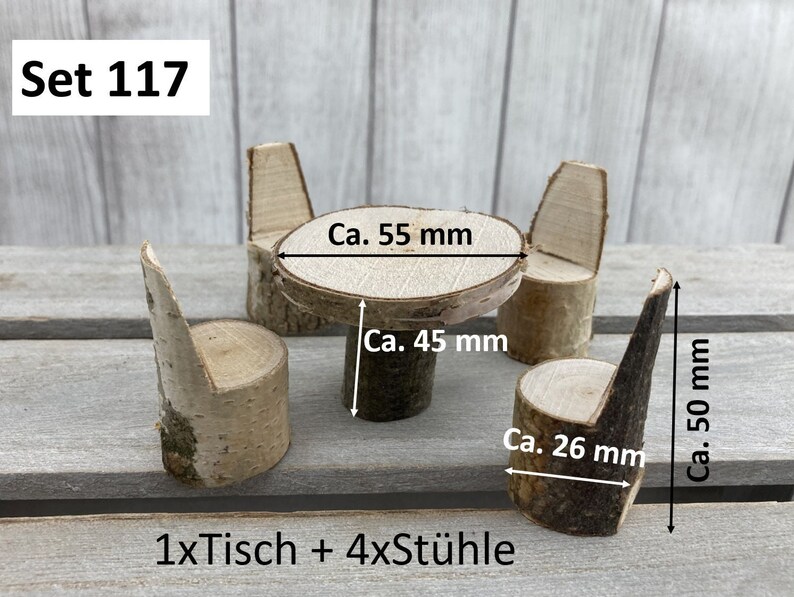 May include: A set of miniature wooden furniture, including a table and four chairs, made from birch wood. The table is 14 cm in diameter and 11.4 cm tall. The chairs are 12.7 cm tall and 6.6 cm wide. The set is labelled "Set 117" and "1xTisch + 4xSt&uuml;hle".