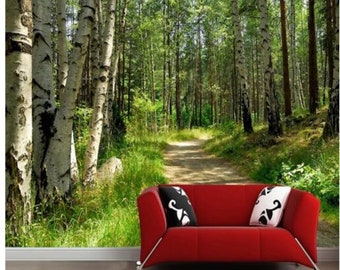 May include: A red couch with black and white pillows sits in front of a photo mural depicting a path through a birch tree forest.