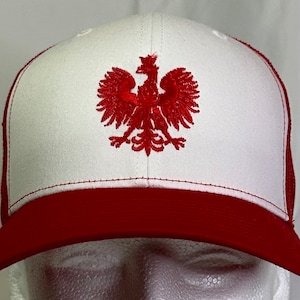 May include: White and red trucker hat with an embroidered red Polish eagle on the front.