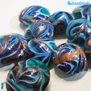 May include: A collection of handmade glass beads with a swirling blue, green, and white pattern and gold accents.