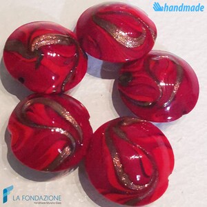 May include: Five handmade Murano glass beads. Each bead is a vibrant red with swirling patterns of brown and gold. The beads are round and glossy, with the word "handmade" in the upper right corner.