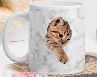 coffee cup cat breaks through.
