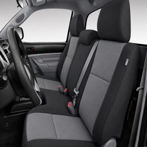 May include: A vehicle interior featuring front bucket seats and a center console covered in two-tone seat covers. The covers are primarily charcoal black on the outer bolsters and headrests, with light gray panels on the backrests and seat cushions.