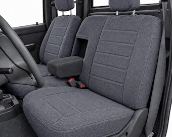 May include: A set of dark gray fabric seat covers installed on vehicle front seats. The covers feature a horizontal stitched pattern, adjustable headrests, and a center console armrest cover. The material has a textured, woven appearance.