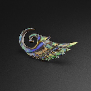 May include: An abalone shell earring with a wing-like design, featuring green, blue and purple colours.