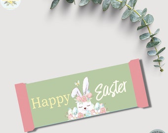 May include: Printable Happy Easter gift tag with a green background, a pink border, and a cute cartoon bunny wearing a flower crown. The bunny is surrounded by pink flowers and eggs.