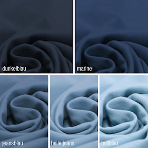 May include: A close-up of fabric swatches in various shades of blue, including dark blue, navy blue, jeans blue, light jeans blue, and light blue. The fabric is folded and textured.