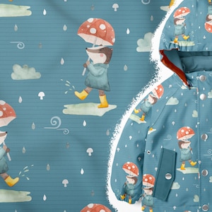 May include: A blue children's raincoat with a repeating pattern of a badger wearing a blue raincoat and holding a red and white mushroom umbrella. The raincoat has a hood and a zip closure.