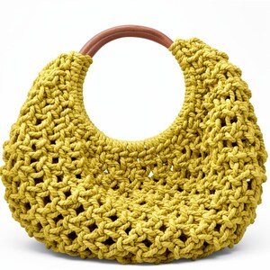 May include: A crescent-shaped handbag crafted from thick, chartreuse-colored cord in an open macrame knot pattern. The bag features a single, smooth, circular wooden handle in a warm brown tone that integrates into the top of the structure.
