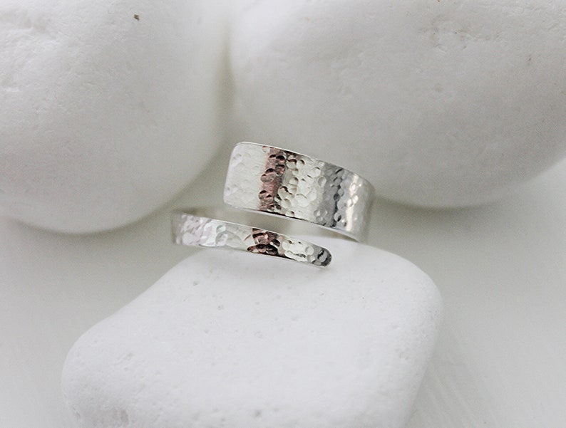 May include: A silver hammered metal ring with a unique wrap-around design.