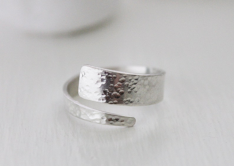 May include: A silver hammered metal ring with a unique twist design.