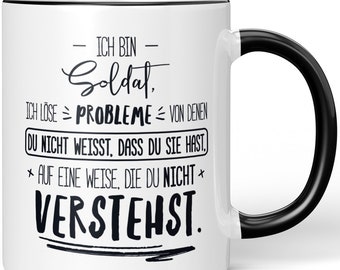 JUNIWORDS Tasse "Ich bin Soldat, ich löse Probleme, von denen du nicht weißt, dass du sie hast, auf eine Weise, die du nicht verstehst"