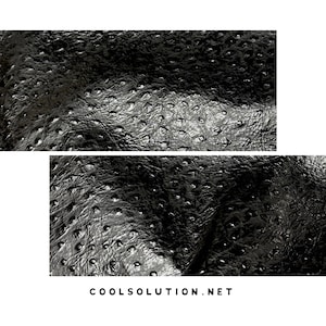 May include: A black material with a textured, bumpy surface resembling ostrich leather, featuring a repeating pattern of small, raised circular indentations across the entire surface. The text COOLSOLUTION.NET is printed in black at the bottom.
