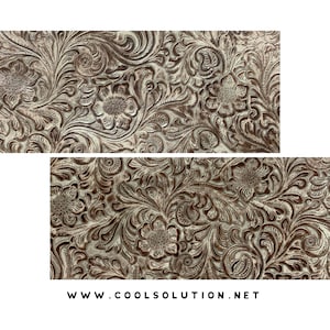 May include: A close-up of a white and brown embossed fabric with a floral pattern. The fabric has a textured, raised design.