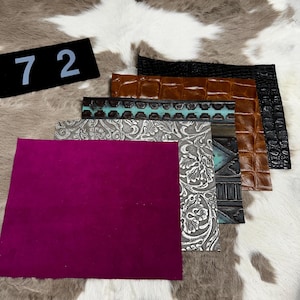 May include: Assortment of leather samples in various colors and textures. Includes a deep magenta suede, embossed silver, turquoise, and brown crocodile-style leather. A black rectangle with the number 72 is in the upper left corner.