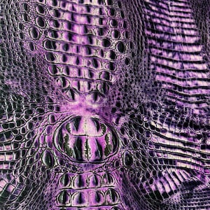May include: Purple and black faux crocodile skin fabric with a textured pattern.