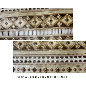 May include: Close-up of a beige and brown patterned fabric with a repeating geometric design. The fabric has a textured surface and a subtle sheen.