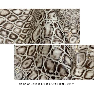 May include: Close-up of a textured, off-white and brown faux leather material with a reptile scale pattern. The material has a glossy finish with gold accents. The website address www.coolsolution.net is printed at the bottom.
