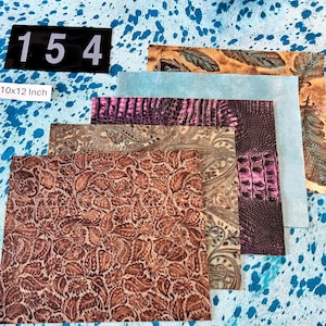 May include: Assortment of leather sheets with various embossed patterns and textures. Includes a brown floral design, a paisley pattern, and a crocodile print in shades of purple. The sheets are approximately 10x12 inches.