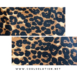 May include: A close-up of a brown and black leopard print fabric. The fabric has a soft, fuzzy texture.