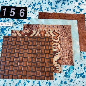 May include: Assortment of leather pieces in various textures and colors. Includes embossed, crocodile, and woven patterns. The pieces are approximately 10x12 inches. The color palette includes shades of brown, tan, and a light blue. The background is a blue and white spotted pattern.