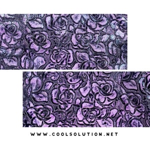 May include: Purple fabric with an embossed rose pattern. The fabric has a subtle shimmer.