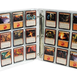 May include: A white binder with clear plastic sleeves holding trading cards. The cards feature fantasy artwork with dragons, monsters, and landscapes.