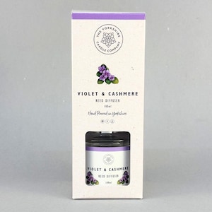 May include: A rectangular cardboard box for a 100ml reed diffuser by The Yorkshire Candle Company. The packaging is cream-coloured with a purple top band, featuring a violet flower illustration, the text Violet & Cashmere, and Hand Poured in Yorkshire.