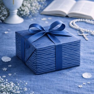 May include: A blue gift box with a white striped pattern and a blue ribbon, set against a blue backdrop. A chalice with a cross, an open book, and a rosary are also visible. The text "F&uuml;r Kommunion, Firmung & Konfirmation" is at the top.