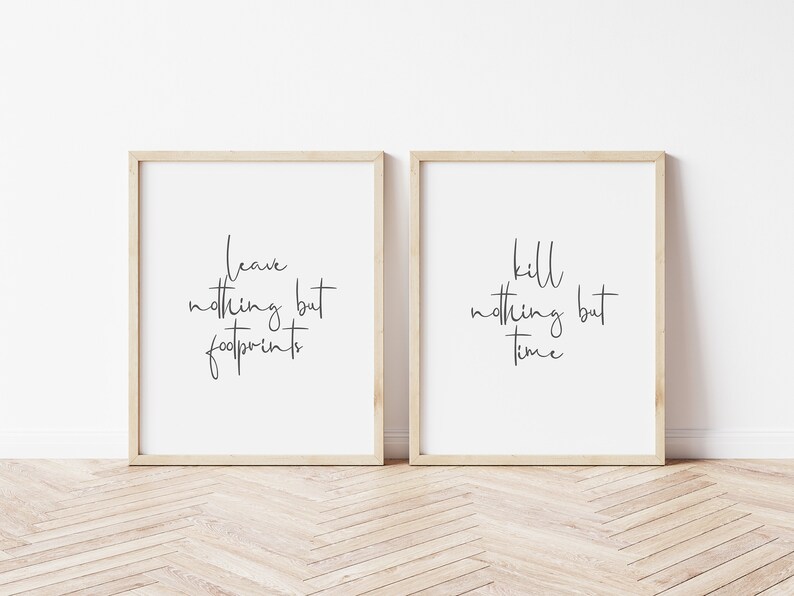 May include: Two framed prints with black calligraphy on white paper. The left print says "leave nothing but footprints". The right print says "kill nothing but time".