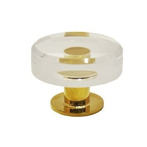 May include: A clear glass cabinet knob with a brass base. The knob has a raised, circular design.