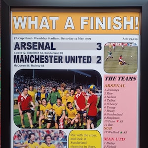 May include: A vintage newspaper clipping from the 1979 FA Cup Final, featuring a photo of the Arsenal team celebrating their victory over Manchester United. The headline reads "What a Finish!" and the score is Arsenal 3, Manchester United 2. The text lists the players for both teams and includes a quote from the ITV commentator Brian Moore.