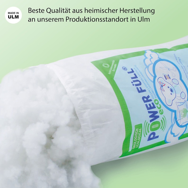 May include: A white bag with a green label that says "POWER F&Uuml;LL&reg; eco" and "&Ouml;KOLOGISCH ECOLOGICAL". The bag is open and white filling is spilling out. The bag has a green seal that says "Made in Germany".