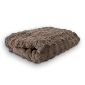May include: A folded, plush blanket in a muted brown colour. The blanket has a textured, faux fur appearance, with visible folds and a soft, inviting look. The blanket is designed for comfort and warmth.