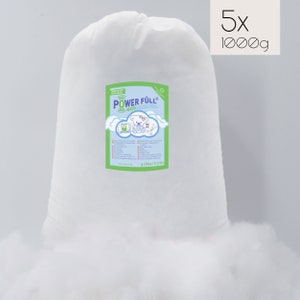 May include: Five bags of white polyester fiberfill, each bag containing 1000 grams of filling. The bags are labeled with the text "POWER FULL eco" and a cartoon bear.