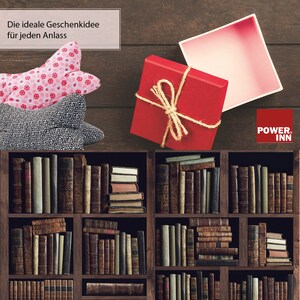 May include: A red gift box with a brown twine bow is open and sitting on a wooden shelf with books. The text "POWER INN" is visible on the right side of the image.