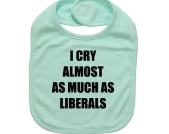 May include: A light blue baby bib with the text "I cry almost as much as liberals" printed in black.
