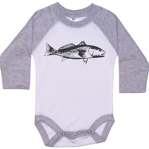 May include: A white and gray long-sleeve baby onesie with a black and white illustration of a fish on the front.