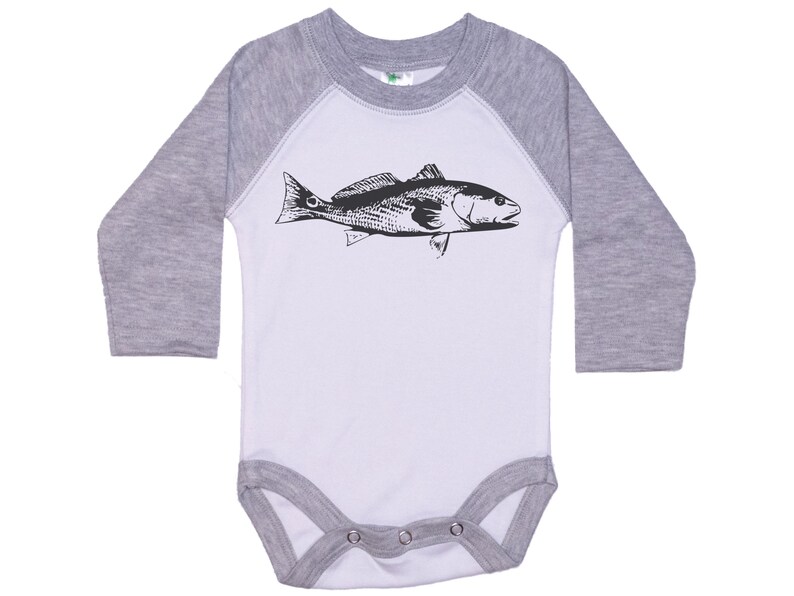 May include: A white and gray long-sleeve baby onesie with a black and white illustration of a fish on the front.