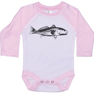 May include: A white baby onesie with pink sleeves and a black and white illustration of a fish on the front. The onesie has three white snaps at the bottom.