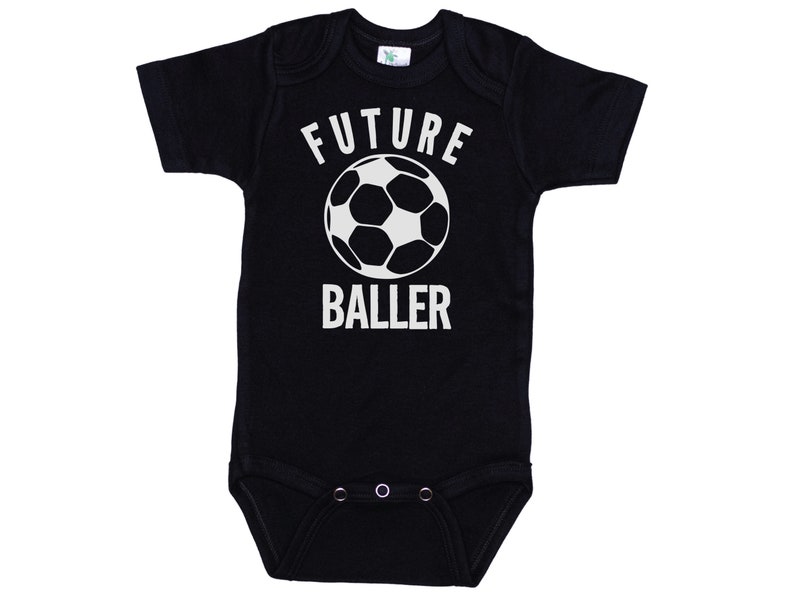 May include: Black baby onesie with white text that says "FUTURE BALLER" and a white soccer ball graphic.