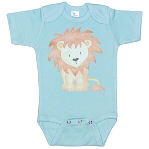 May include: A light blue baby onesie with a watercolor illustration of a lion in orange and brown colors.