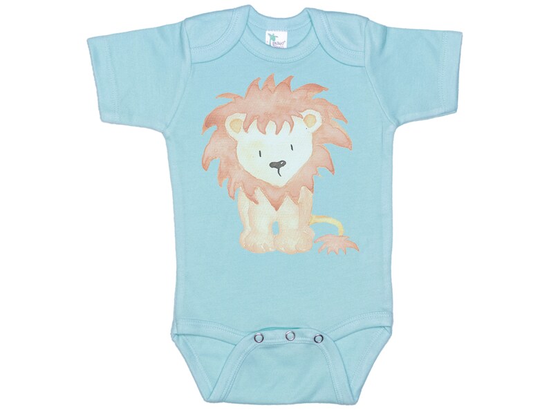May include: A light blue baby onesie with a watercolor illustration of a lion in orange and brown colors.