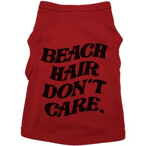 May include: Red sleeveless dog shirt with black text that reads "Beach Hair Don't Care."