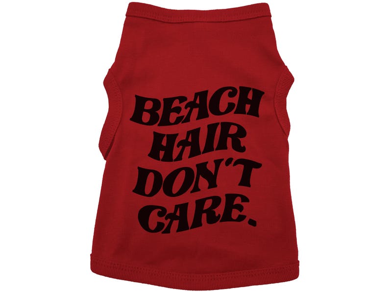 May include: Red sleeveless dog shirt with black text that reads "Beach Hair Don't Care."