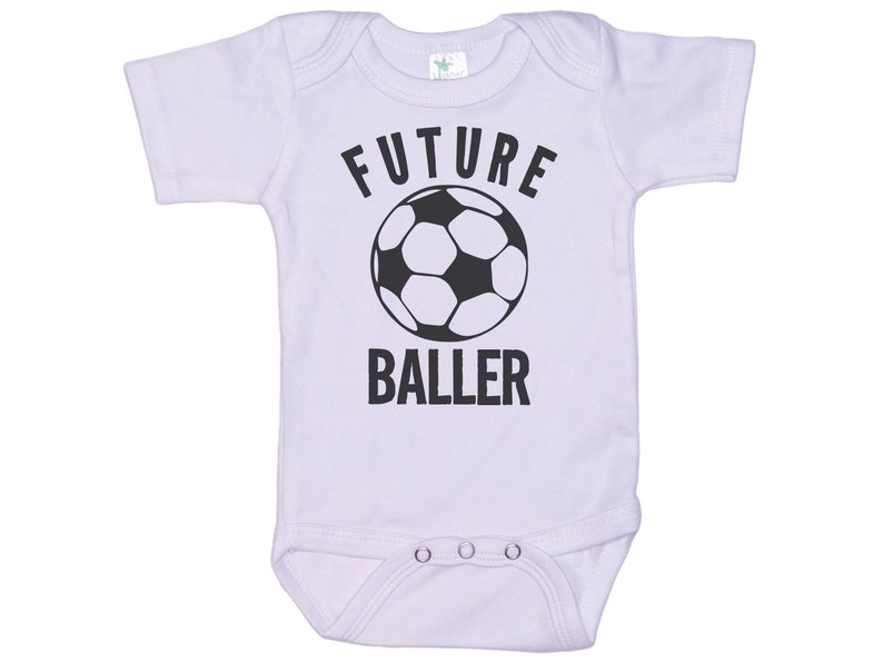 May include: White baby onesie with black text that reads "FUTURE BALLER" and a black and white soccer ball graphic.