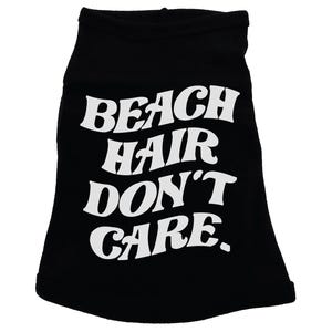 May include: Black dog shirt with white text that reads "Beach Hair Don't Care."