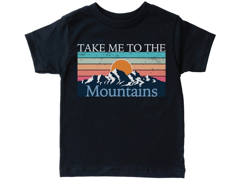 May include: A black t-shirt with a vintage-style graphic of mountains and a sunset. The text "Take Me To The Mountains" is printed on the shirt.